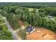 Aerial view showcases a newly constructed home nestled among lush trees, emphasizing its private and scenic location at 315 Bonaventure Dr, Salisbury, NC 28147