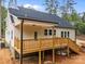 Back porch view with wood railing and stairs, showcasing the home's outdoor living space, set in nature at 315 Bonaventure Dr, Salisbury, NC 28147