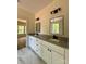 This modern bathroom features double sinks, granite counters, and sleek fixtures, with a view into another room at 315 Bonaventure Dr, Salisbury, NC 28147
