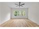 Bright bedroom with wood-look floors and large windows offering a nature view of the surrounding trees at 315 Bonaventure Dr, Salisbury, NC 28147