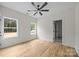 A bedroom with wood-look floors and windows facing lush greenery at 315 Bonaventure Dr, Salisbury, NC 28147