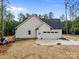 Exterior view showcasing a two-car garage and a level, unfinished yard, highlighting potential for landscaping at 315 Bonaventure Dr, Salisbury, NC 28147