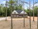 New traditional home featuring a brick facade, ample windows, and a lush, wooded surrounding at 315 Bonaventure Dr, Salisbury, NC 28147