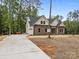 New traditional home with a brick facade, a two-car garage, and a long driveway at 315 Bonaventure Dr, Salisbury, NC 28147