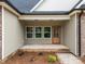 Inviting front entrance with three windows and a wood door, set against a backdrop of neutral-toned siding at 315 Bonaventure Dr, Salisbury, NC 28147