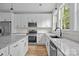 Close-up of a modern kitchen with stainless steel appliances, granite countertops, and ample cabinet space at 315 Bonaventure Dr, Salisbury, NC 28147