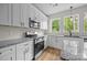 Detailed view of the kitchen with stainless steel appliances, granite counters, and white cabinets at 315 Bonaventure Dr, Salisbury, NC 28147