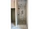 The walk-in shower is tiled with marble and mosaic tile, has glass doors, and features modern fixtures at 315 Bonaventure Dr, Salisbury, NC 28147