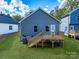 A backyard showcasing a private deck, complemented by a lush green lawn at 606 Meadow Ave, Spencer, NC 28159