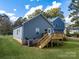 A backyard showcasing a private deck, complemented by a lush green lawn at 606 Meadow Ave, Spencer, NC 28159