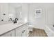 Bright bathroom featuring a white vanity, black fixtures, and wood-look flooring for a modern aesthetic at 606 Meadow Ave, Spencer, NC 28159