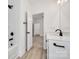 Well-lit bathroom showcases a white tub, modern fixtures, and doorway to another room at 606 Meadow Ave, Spencer, NC 28159