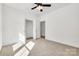Cozy bedroom features neutral carpet, ceiling fan, and a convenient closet for ample storage space at 606 Meadow Ave, Spencer, NC 28159