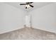Serene bedroom with neutral carpet, ceiling fan, and a doorway leading to another room at 606 Meadow Ave, Spencer, NC 28159