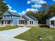A well-manicured lawn frames a gray home featuring a concrete driveway and sidewalk at 606 Meadow Ave, Spencer, NC 28159