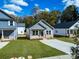 View of the new construction home with a concrete driveway and fresh green lawn at 606 Meadow Ave, Spencer, NC 28159