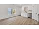 Bright kitchen adjacent to a living area with stainless steel dishwasher and modern design at 606 Meadow Ave, Spencer, NC 28159