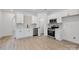New kitchen featuring sleek white cabinets, stainless steel appliances, and modern finishes at 606 Meadow Ave, Spencer, NC 28159