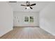 A well-lit, open living room boasts wood-look floors, complemented by a modern ceiling fan at 606 Meadow Ave, Spencer, NC 28159