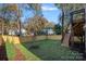 Landscaped backyard with wooden fence and raised deck at 705 Mcalway Rd, Charlotte, NC 28211