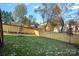 Landscaped backyard with wooden fence and mature trees at 705 Mcalway Rd, Charlotte, NC 28211