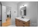 Clean bathroom with light wood vanity and marble countertop at 705 Mcalway Rd, Charlotte, NC 28211