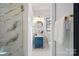 Modern powder room with blue vanity and marble shower at 705 Mcalway Rd, Charlotte, NC 28211