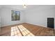 Bright bedroom with hardwood floors, large window, and neutral color scheme at 705 Mcalway Rd, Charlotte, NC 28211