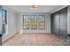 Bright bedroom featuring hardwood floors and large windows at 705 Mcalway Rd, Charlotte, NC 28211