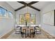 Bright dining room with hardwood floors, large windows, and a modern light fixture at 705 Mcalway Rd, Charlotte, NC 28211