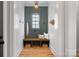 Functional mudroom with built-in bench, hooks, and a calming color scheme at 705 Mcalway Rd, Charlotte, NC 28211