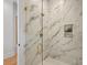 Walk-in shower with marble tile and gold fixtures at 705 Mcalway Rd, Charlotte, NC 28211