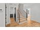 Elegant staircase with light wood treads and black metal railing at 705 Mcalway Rd, Charlotte, NC 28211