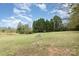 Open land with a large rock and trees at 2830 Sparrow Springs Rd, Gastonia, NC 28052