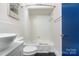 Clean bathroom with white tile, bathtub, and updated fixtures at 400 Queens Rd # E5, Charlotte, NC 28207