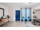 Entryway with blue door, patterned curtains, and a small table at 400 Queens Rd # E5, Charlotte, NC 28207