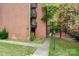 Brick building exterior with landscaping and walkway at 400 Queens Rd # E5, Charlotte, NC 28207