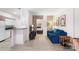 Bright living room with blue sofa, and view into bedroom and kitchen at 400 Queens Rd # E5, Charlotte, NC 28207