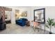 Living room features blue sofa, a work desk, and a mirror reflecting the kitchen at 400 Queens Rd # E5, Charlotte, NC 28207