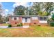 Brick ranch home with a screened porch and well-maintained lawn at 403 Little St, Lincolnton, NC 28092