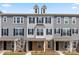 Three-story townhome with gray siding, brick accents, and two-car garage at 7113 Brookview Ln, Sherrills Ford, NC 28673