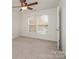 Well-lit bedroom featuring two windows and ceiling fan at 105 Beverly Chase Ln, Mooresville, NC 28117