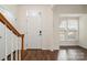 Bright entryway with hardwood floors, coat closet, and staircase at 105 Beverly Chase Ln, Mooresville, NC 28117