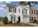 Two-story townhome with white siding and a black door at 105 Beverly Chase Ln, Mooresville, NC 28117