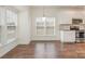 Bright kitchen features hardwood floors, stainless steel appliances, and white shaker cabinets at 105 Beverly Chase Ln, Mooresville, NC 28117