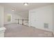 Spacious loft area with neutral carpeting and a charming window at 105 Beverly Chase Ln, Mooresville, NC 28117