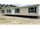 Tan double wide manufactured home with black shutters and a white door at 1131 Colonial Rd, Clover, SC 29710