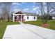 Newly built home with red and white siding, a covered porch, and a concrete driveway at 1244 Bob Falls Rd, Shelby, NC 28150