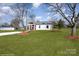 Newly built home with red and white siding, a covered porch and a landscaped yard at 1244 Bob Falls Rd, Shelby, NC 28150