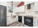 Modern kitchen with white cabinets, stainless steel appliances, and a farmhouse sink at 1244 Bob Falls Rd, Shelby, NC 28150